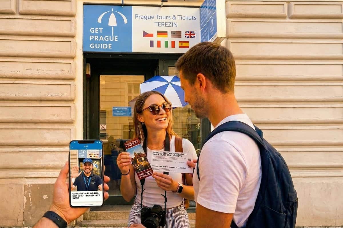 A woman and a man standing outside a tour office in Prague, holding a ticket and a smartphone showing a tour guide app.